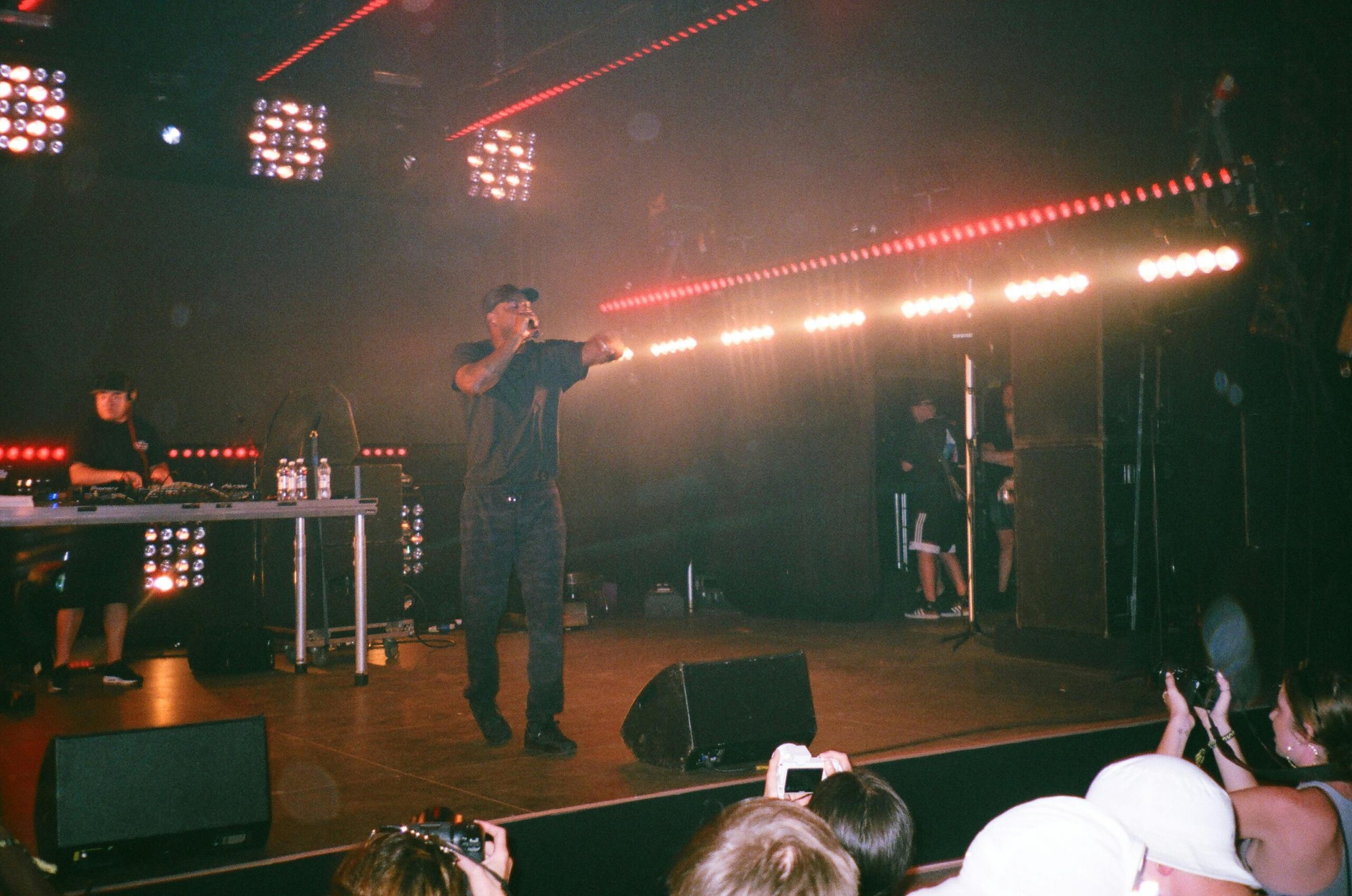 Energetic rap performance with vibrant stage lights and an engaged crowd.